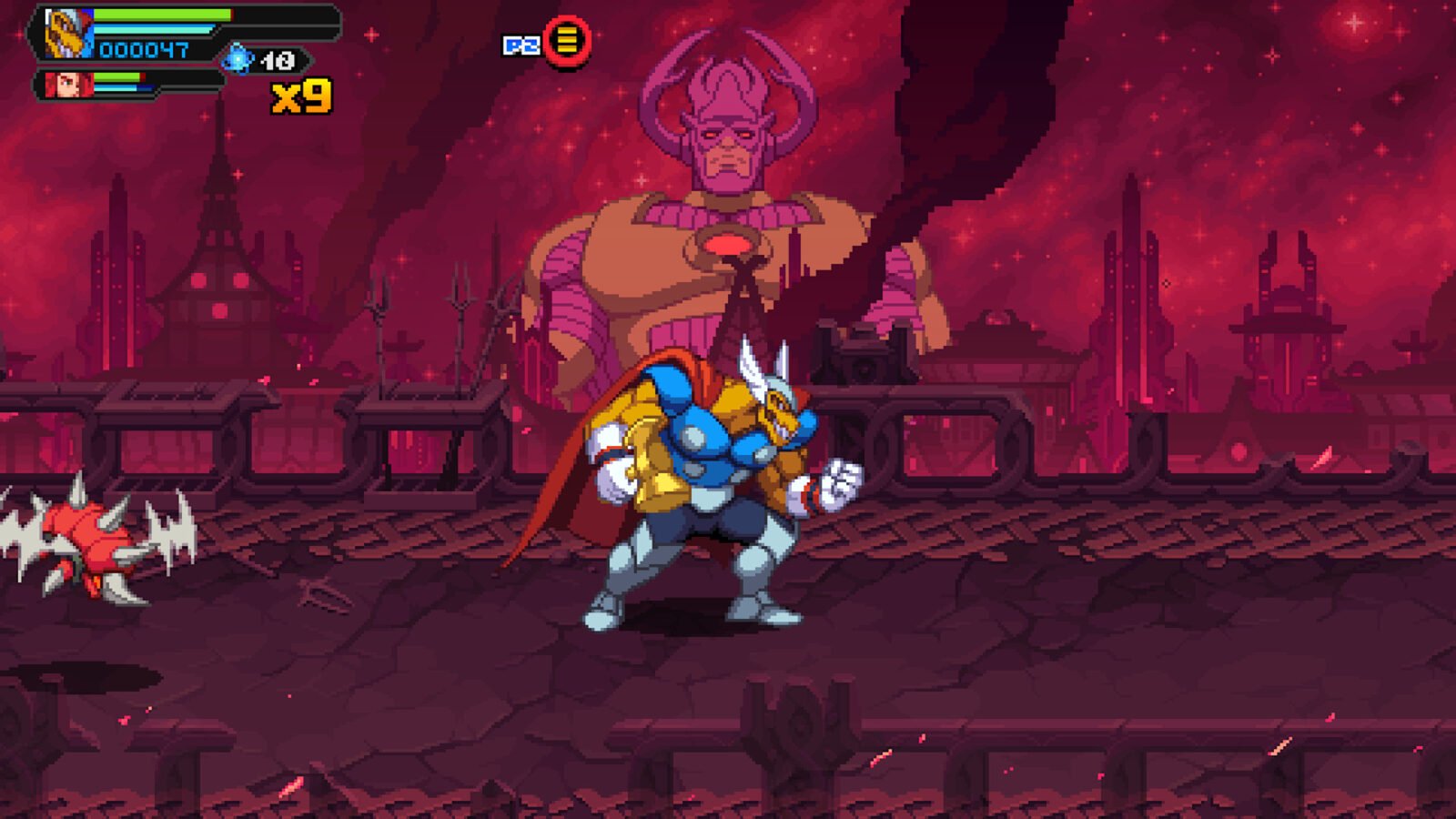 Bill Raio Beta, em seu uniforme azul e dourado e com capa vermelha, está em pose de combate em um planeta vermelho e devastado. Ao fundo, paira a figura imponente e gigante de Galactus, com fumaça escura emanando de seu corpo.